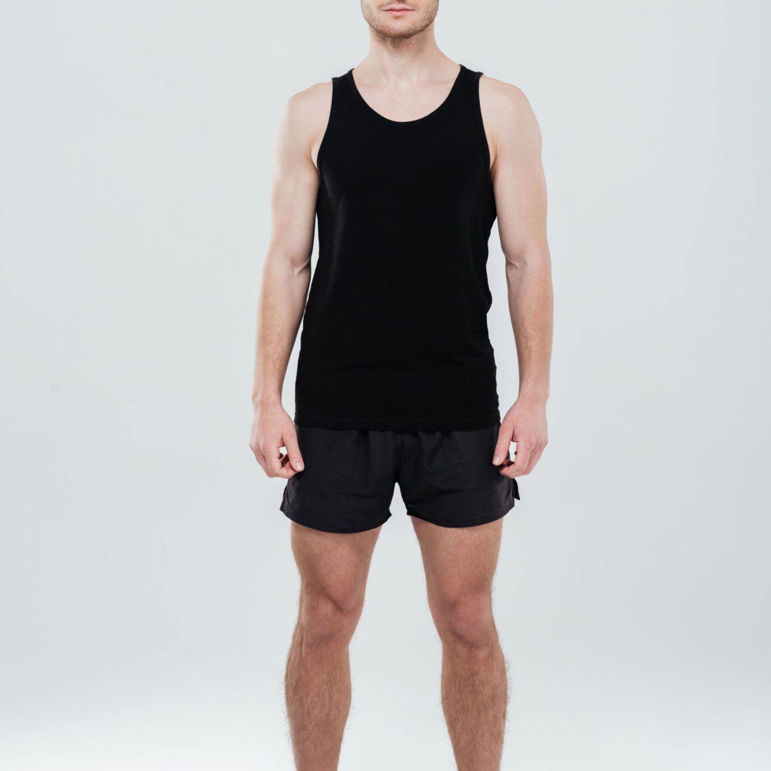 Image of concentrated young sportsman standing isolated over white background. Looking at camera.
